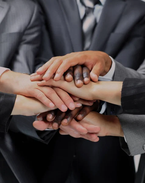 Diverse group of workers with their hands together in form of teamwork — Stock Photo, Image