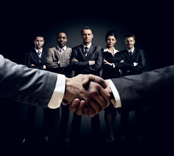 Handshake on the background group of business people — Stock Photo, Image