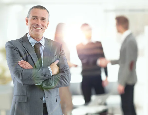 Portrait of an handsome businessman in front of his team — Stock Photo, Image