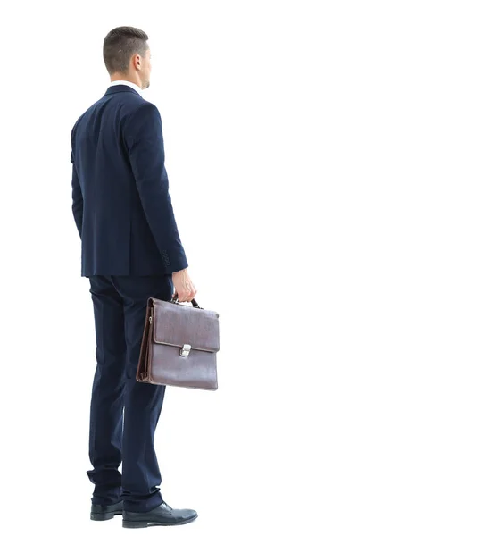 Молодий продавець бізнесмен в елегантному костюмі, що стоїть спиною в порожній концепції білого простору — стокове фото