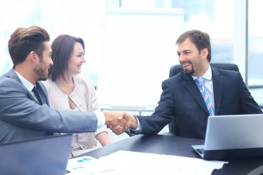 İki ile bir toplantı sırasında bir masada oturan iş arkadaşları