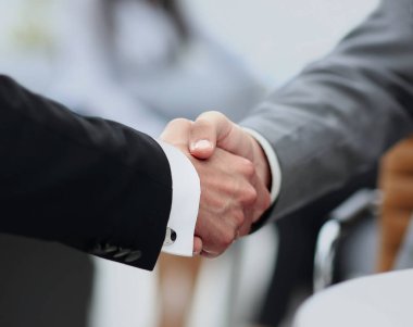 bir anlaşma üzerinde el sıkışan iş adamları