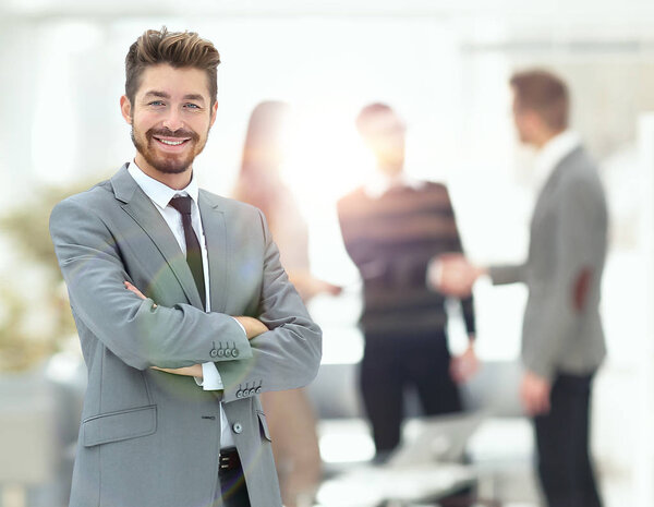 Portrait of an handsome businessman in front of his team