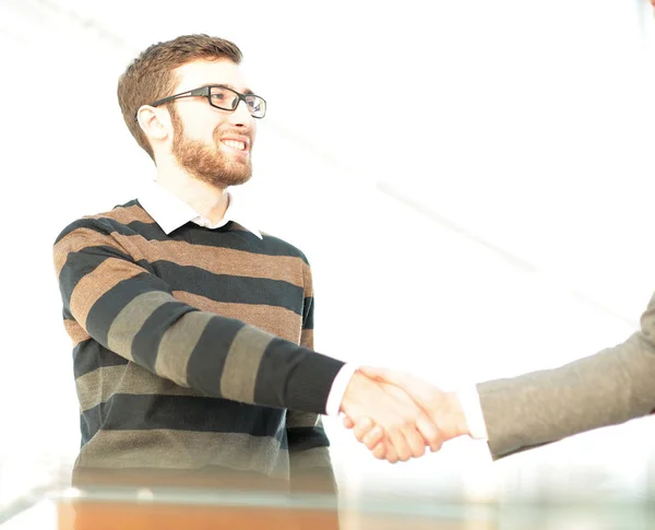 Business man giving a handshake and smiling — Stock Photo, Image
