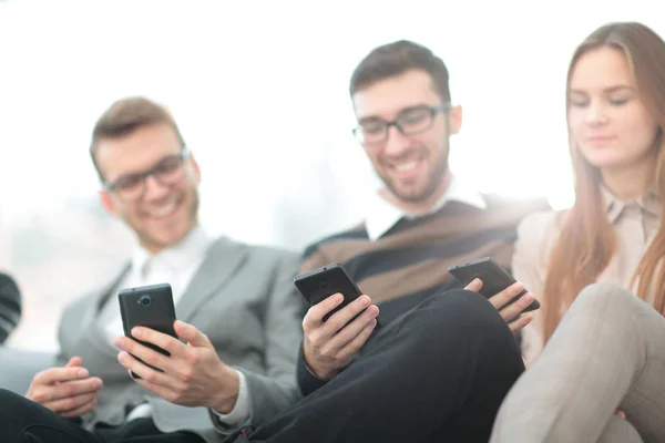 Group of young people use their phones — Stock Photo, Image