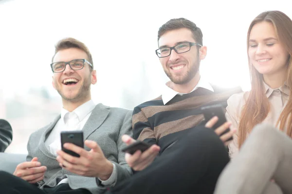 Bir grup genç ve mutlu genç insan onların telefonları ve c kullanarak — Stok fotoğraf
