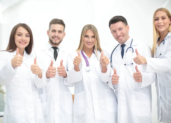 Portrait of happy doctors team showing thumbs up