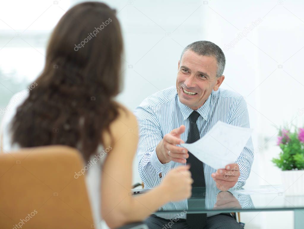 boss discusses with the assistant business documents in the offi