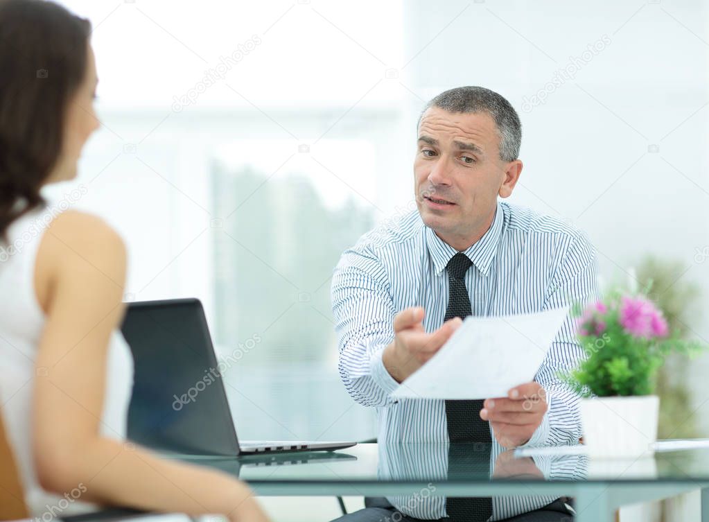 insurance agent shows the contract to the client in the office b