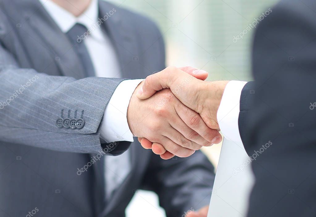 Business man shaking hand to partner