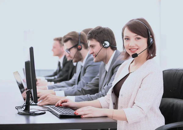 Beautiful woman assistant with a headset in a call center on the — Stock Photo, Image