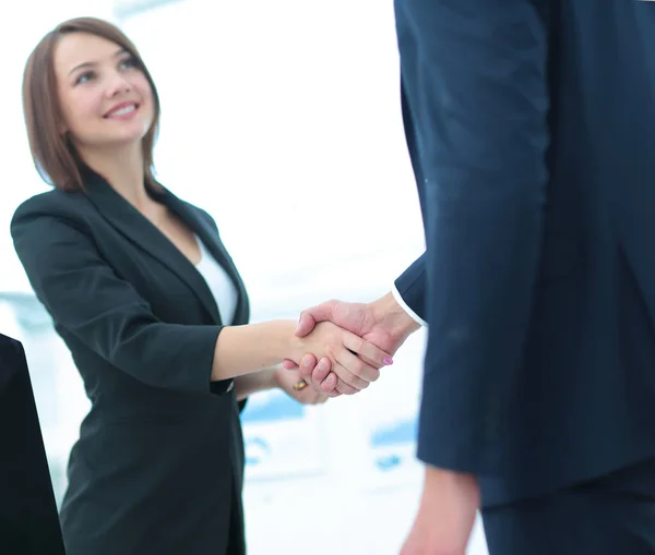 Business handshake. Two business people shaking hands in office.