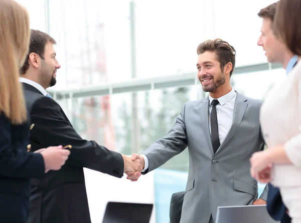 Two business people shaking hands at the business meeting with t — Stock Photo, Image