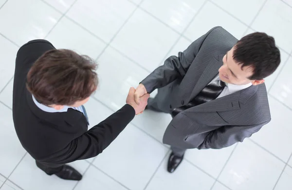 Two business people shaking hands with each other in the office — Stock Photo, Image