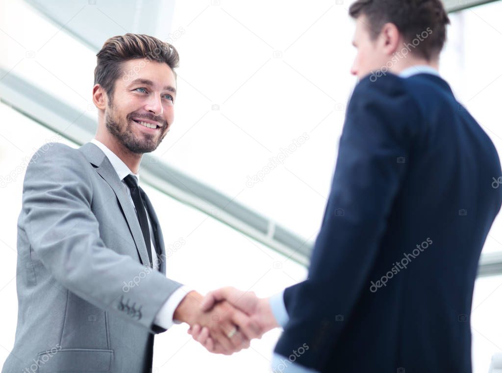 Business handshake. Two business people shaking hands in office.