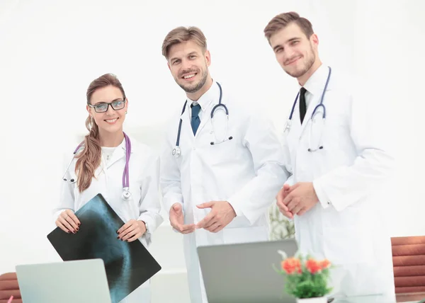 Portrait of group of smiling hospital colleagues standing togeth