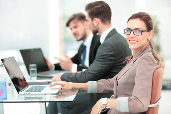 Portrait of happy business woman with  colleagues interacting on