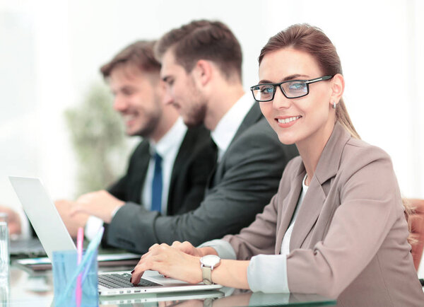 Portrait of happy business woman with  colleagues interacting on