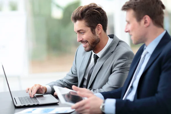 Two handsome businessmen working together on a project in the of — Stock Photo, Image
