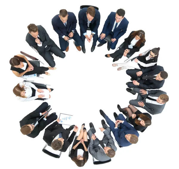 Diverse group pf young business people seated round a table disc — Stock Photo, Image