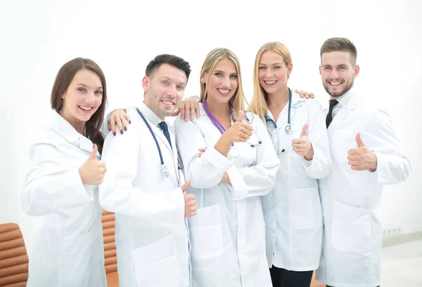 Happy and confident team of doctors posing on camera — Stock Photo, Image