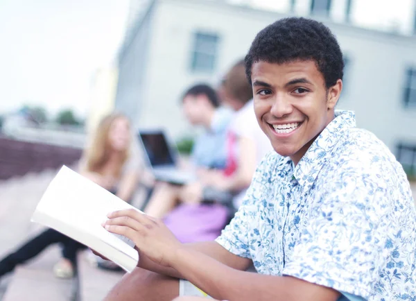 Young boy sitting with friends — Stock Photo, Image