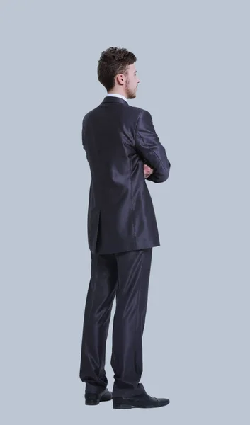 Молодий бізнесмен повний вид збоку тіла ізольований на сірому фоні — стокове фото