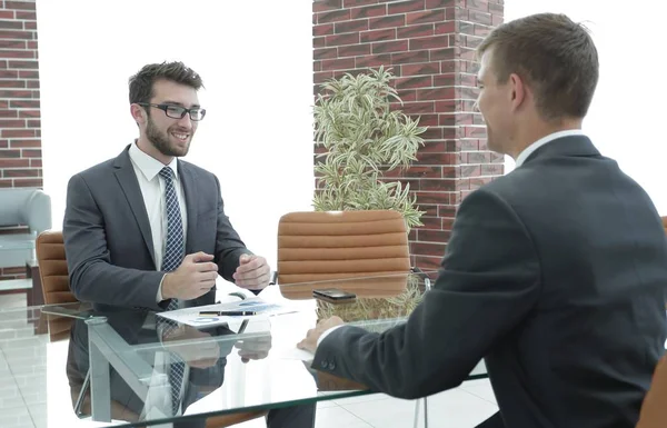 business partners are discussing a financial chart