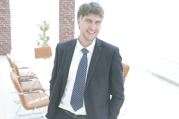 Businessman on a background of an empty conference room — Stock Photo, Image