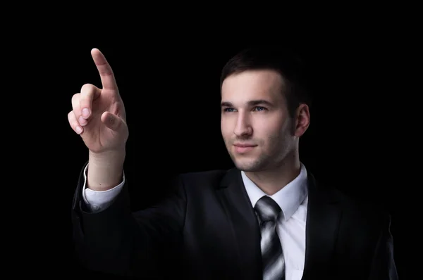 Business man pressing an imaginary button. Isolated on black. — Stock Photo, Image