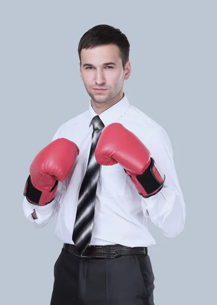 Businessman ready to fight with boxing gloves over gray — Stock Photo, Image