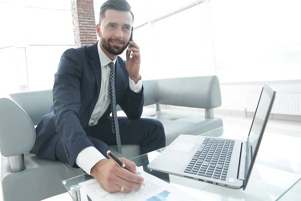 Uomo d'affari che parla su smartphone di grafici finanziari . — Foto Stock