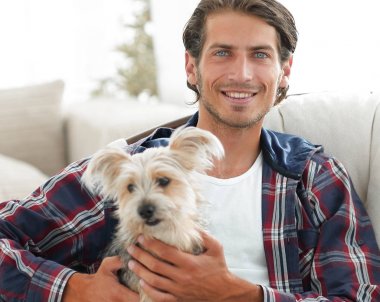 yakışıklı olan büyük bir koltukta oturan bir köpekle.