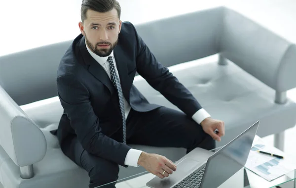 Businessman working on a laptop with financial charts — Stock Photo, Image