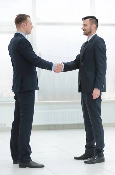 Handshake financial partners in the corridor of the office Stock Image