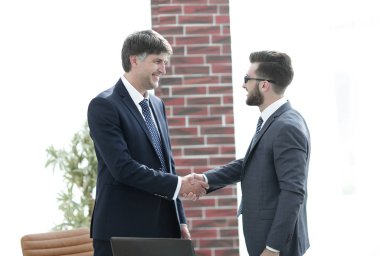 ofis koridorunda duran el sıkışan işadamları