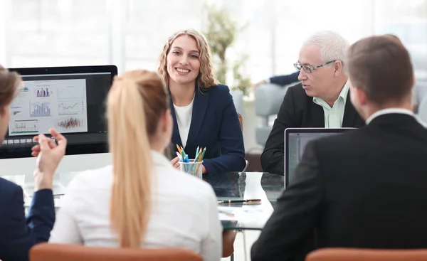 Group of confident business partners discussing paper at the meeting — Stock Photo, Image