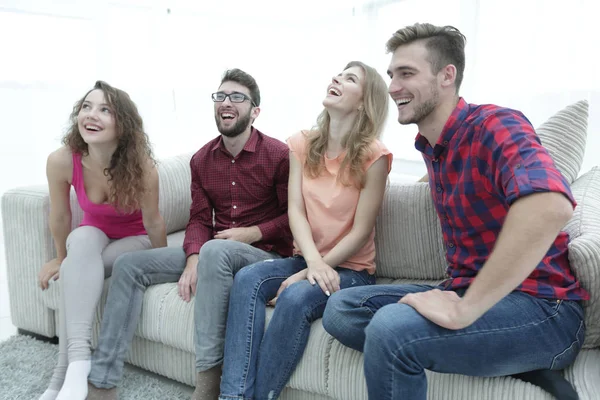 Group of smiling young people sitting on the couch — Stock Photo, Image