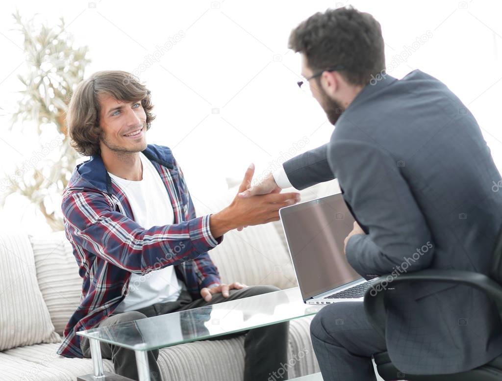 manager shakes hands with his client