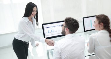 Çalışanlar birbirlerini masanın yakınında bir el sıkışma ile selamlıyorum