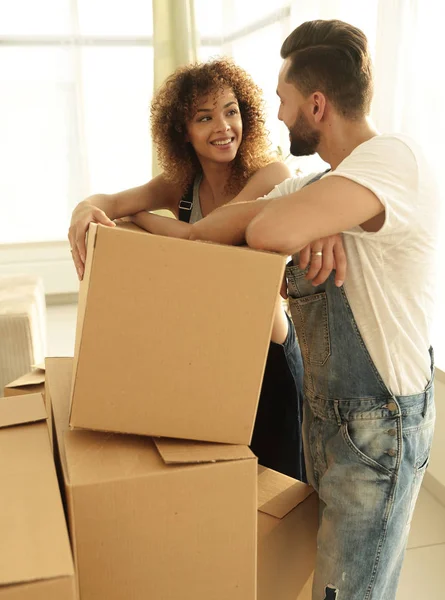 Joyeux couple debout près des boîtes dans leur nouvel appartement . — Photo