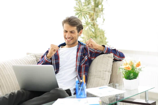 幸せな男は、自宅からノート パソコンでの作業します。フリーランスの概念. — ストック写真