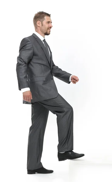 In full growth.side view.businessman dando un paso adelante — Foto de Stock