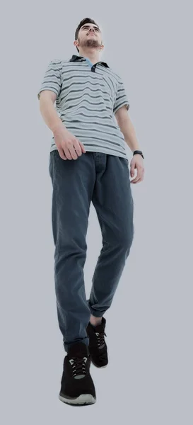 Bottom view of a smiling young casual man walking, on a white ba — Stock Photo, Image