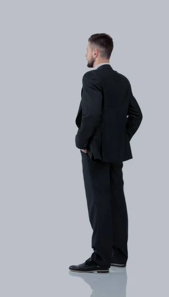 Businessman from the back - looking at something over a white ba — Stock Photo, Image