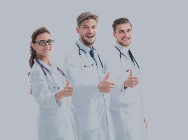 Equipo de profesionales médicos mirando a la cámara, mostrando pulgares — Foto de Stock