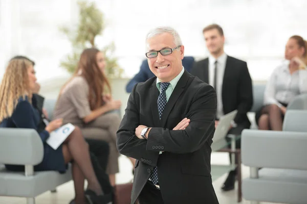 Souriant homme d'affaires senior sur le fond de l'équipe d'affaires — Photo