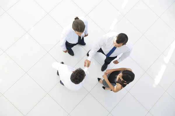 View from the top. colleagues shaking hands in office lobby. — Stock Photo, Image