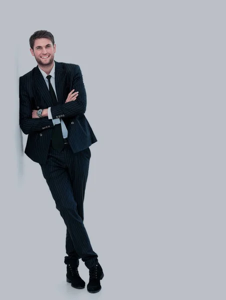 Portrait of a handsome young man in a business suit. standing near the wall — Stock Photo, Image