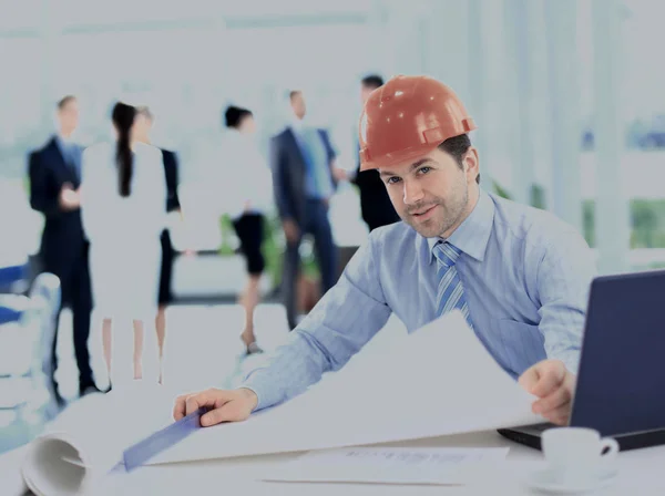 Een knappe zakenman met bouw op de werkplek — Stockfoto